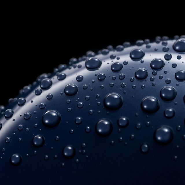 Water beading on a protected marine surface at dusk